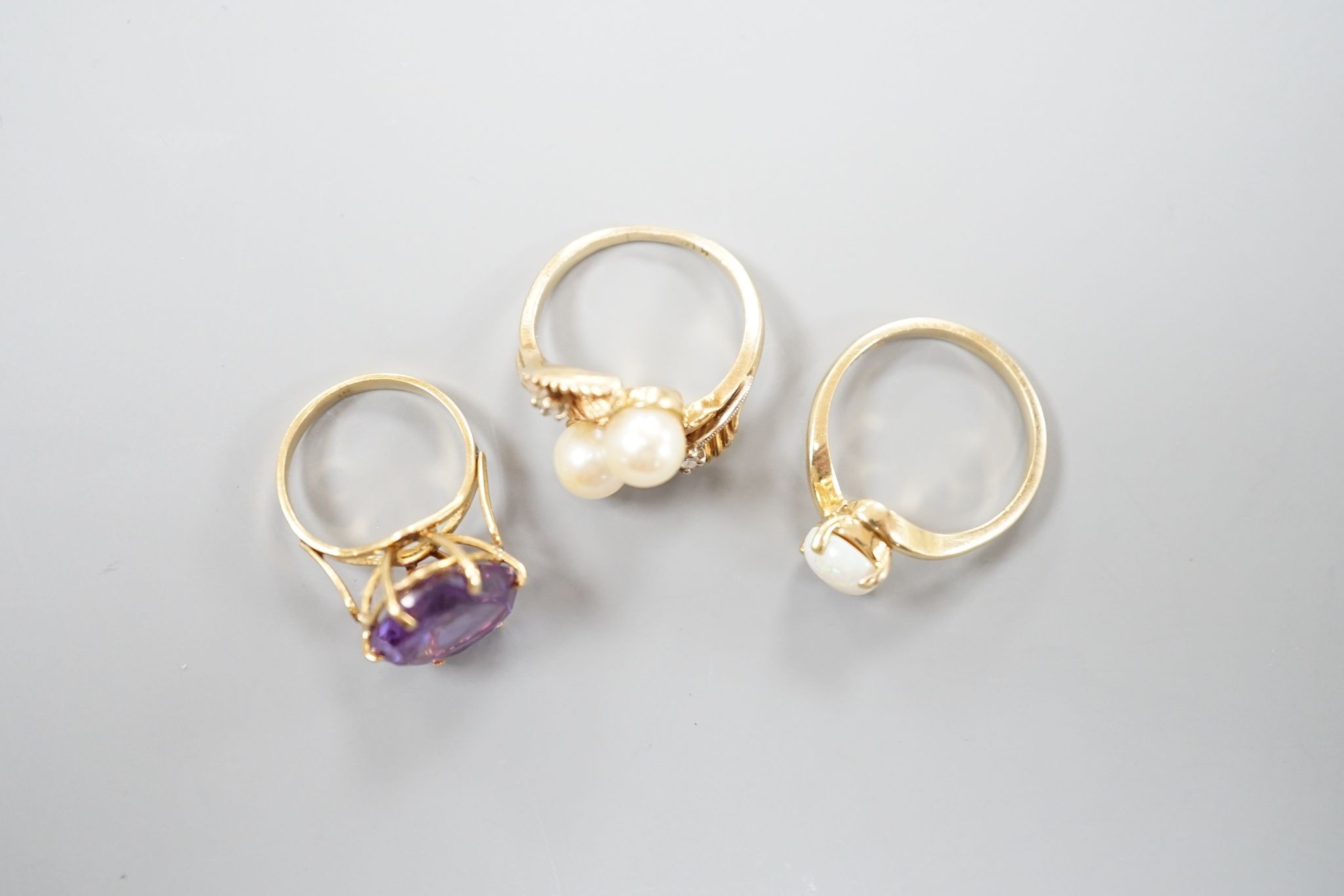 Three assorted modern 14k and gem set dress rings, including white opal, size L, gross 10.3 grams